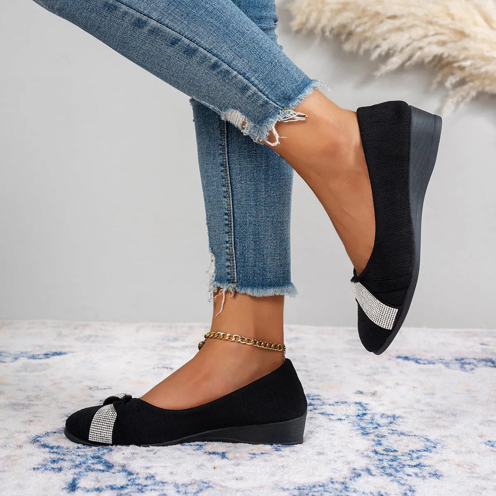 Black women's low-cut slip-on casual shoes with rhinestone decoration and a chunky short heel.