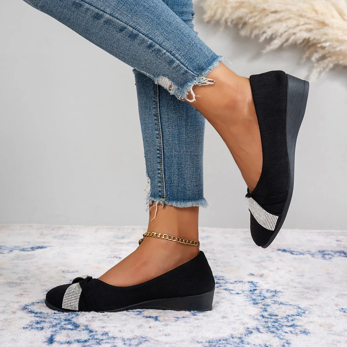 Black women's low-cut slip-on casual shoes with rhinestone decoration and a chunky short heel.
