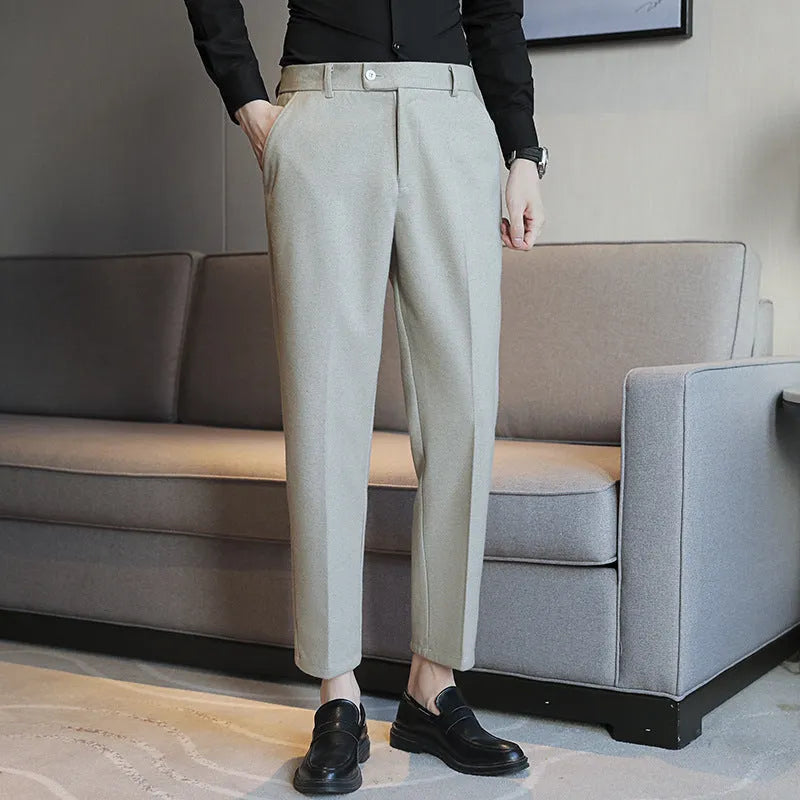 Men's straight leg brown corduroy trousers with an elasticated waistband on a hanger