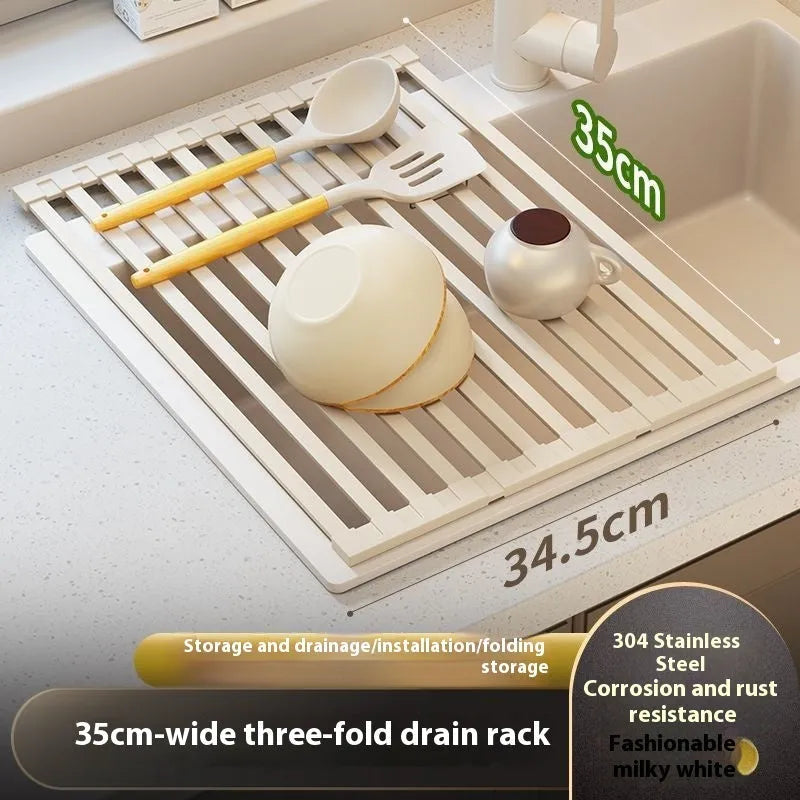 Milky white foldable stainless steel kitchen draining rack shown next to a sink.