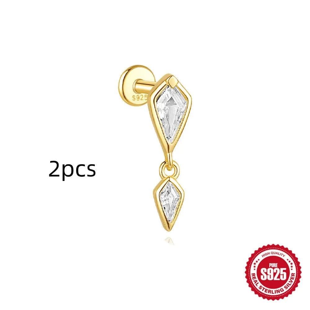 Geometric kite-shaped sterling silver earring with rhinestone head and gold chain tassel.