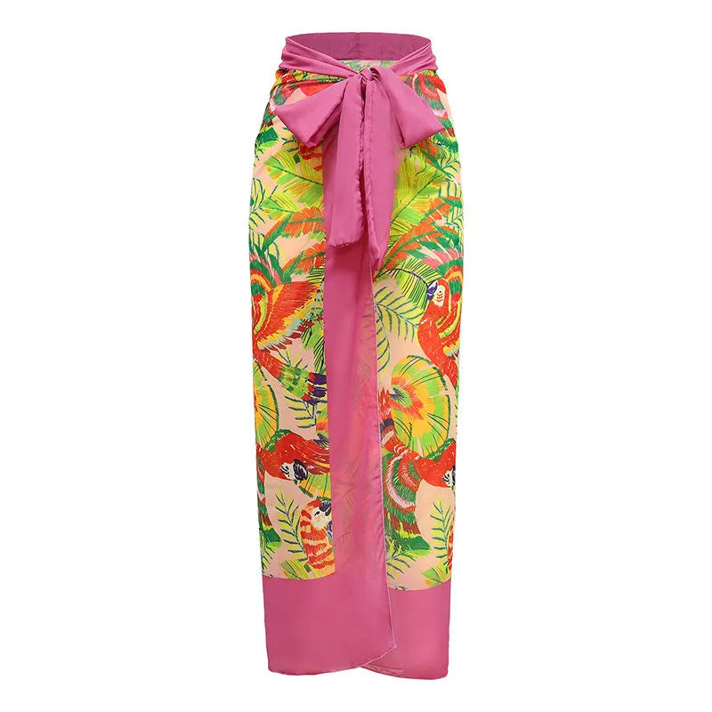 Pink floral print one-piece swimsuit with V-neck, covered belly, and an attached skirt.