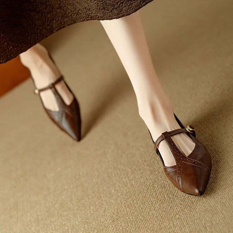 Brown women's casual cowhide flat shoes with round toe and soft bottom, shown with a skirt.
