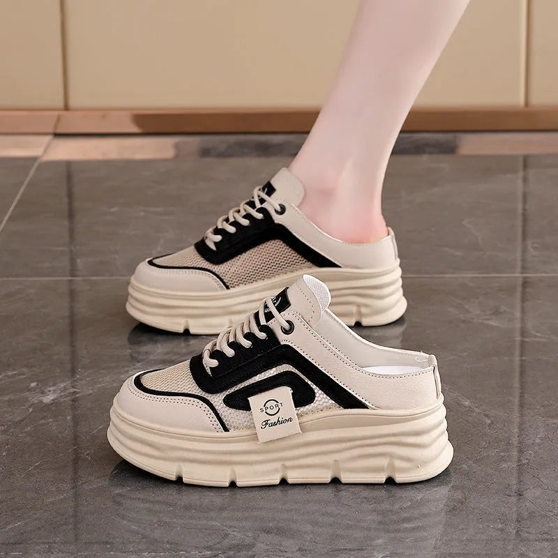 Women's black breathable mesh half slippers with round toe and rubber sole on a white background.