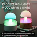 White cloud rain humidifier with rainfall simulation and LED lighting on wooden surface