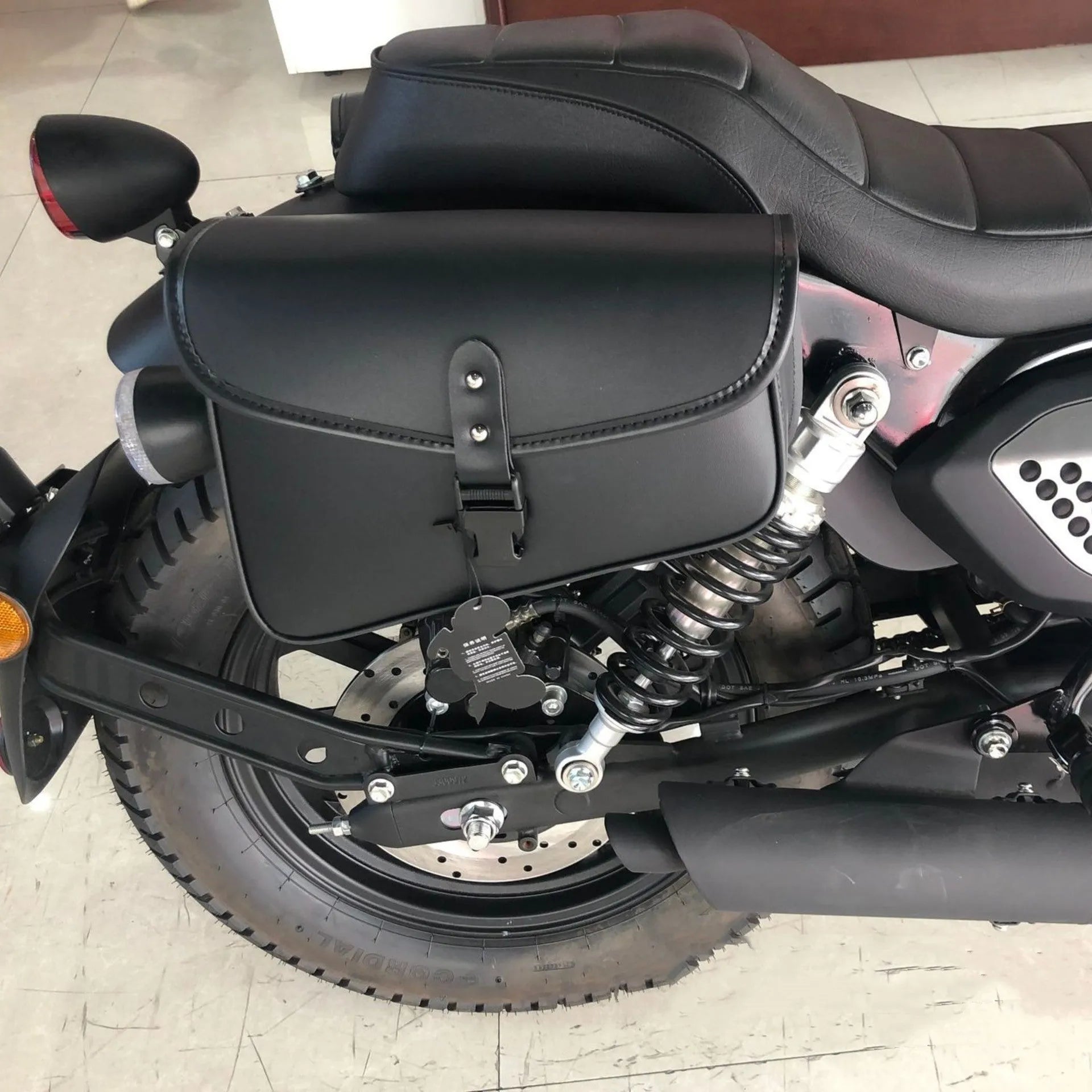 Black motorcycle swingarm side saddlebag mounted on Harley Davidson Sportster