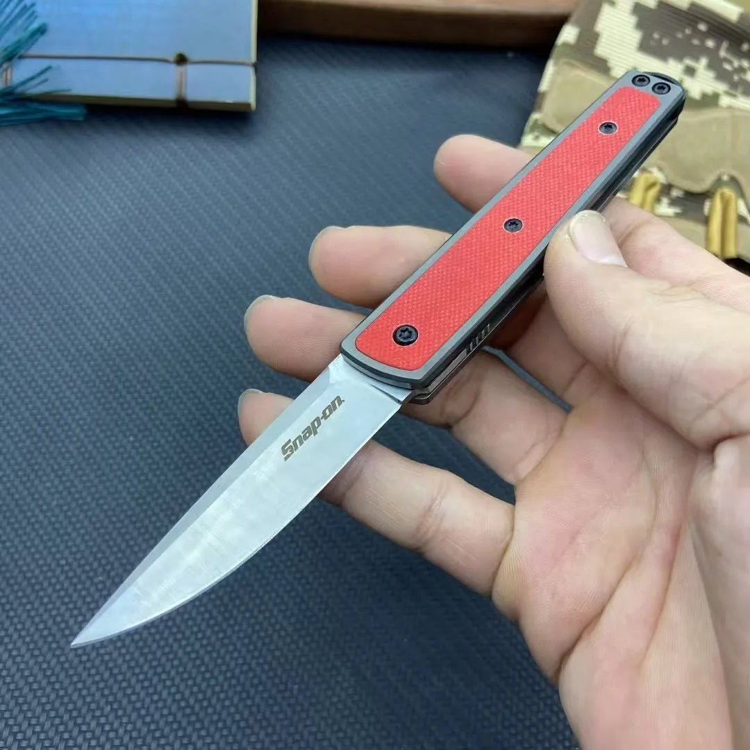 Folding fruit knife with stainless steel blade shown in black, brown, and red colour options