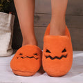 Orange pumpkin design Halloween slippers with plush lining and PVC sole for indoor home wear