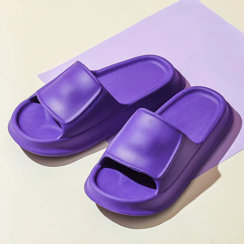 Pair of thick-soled EVA flip flop slippers in purple, showing deep sole profile.