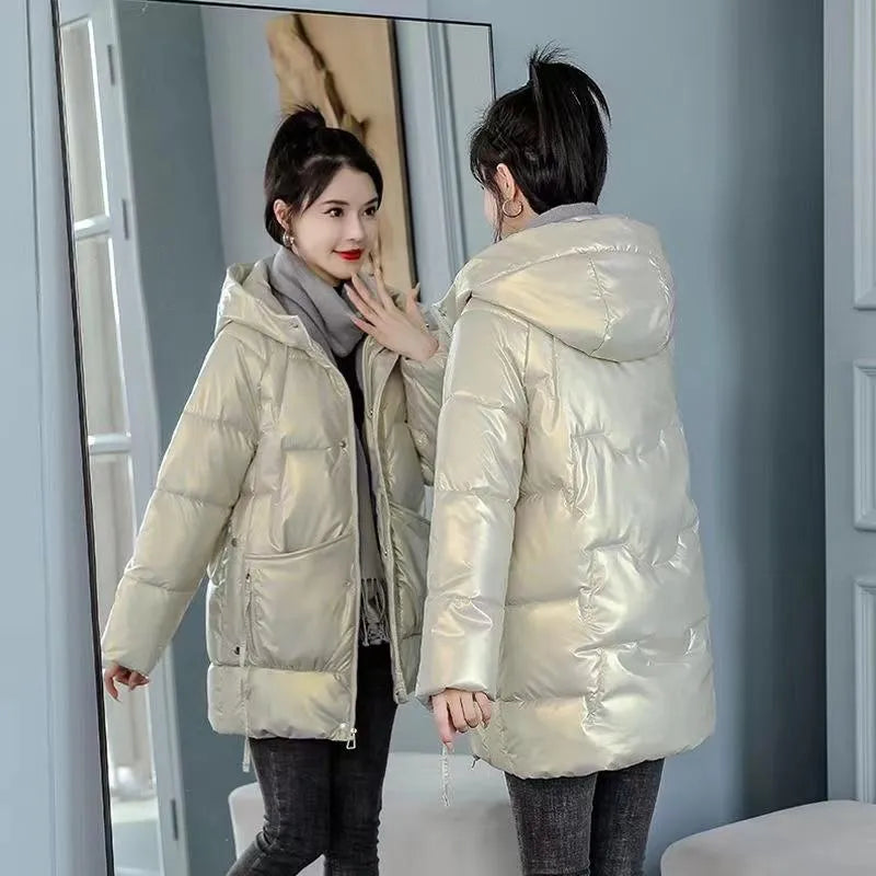 Women's loose fit hooded winter jacket in green colour showing long sleeves and thick insulation