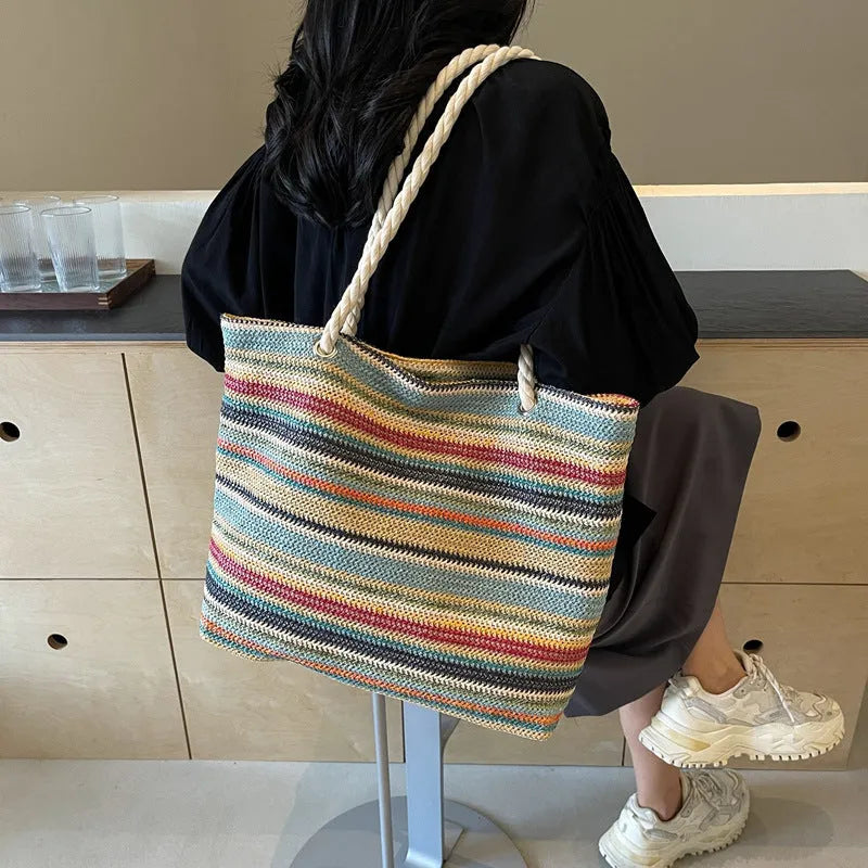 Blue straw-woven nylon shoulder bag with large main compartment and single strap