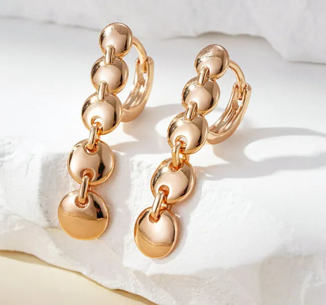 Gold woven copper circle earrings with retro circular design