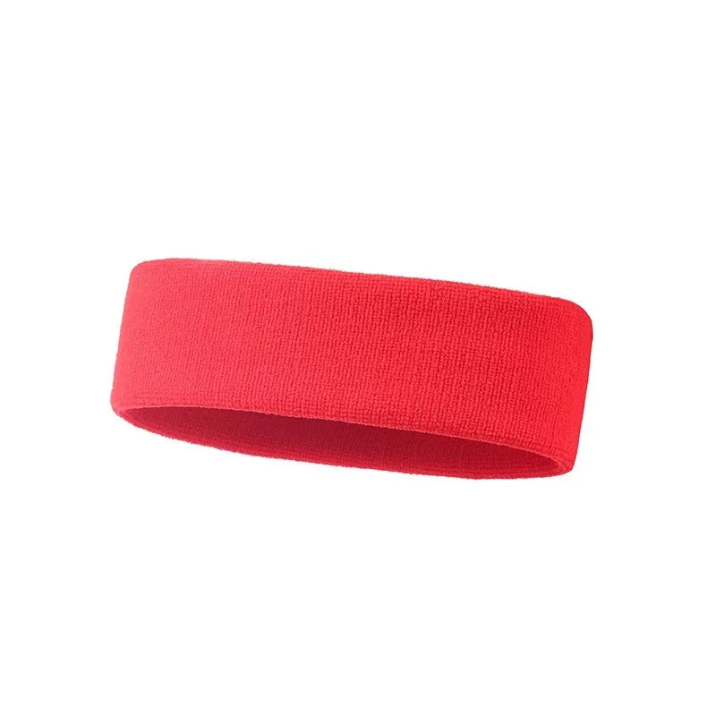 Elastic solid colour sports sweat band in black, shown on a forehead.