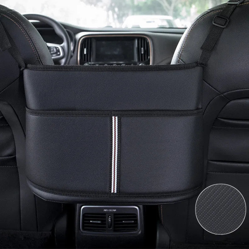 Black leather car seat storage bag with a carbon fibre pattern, shown mounted between car seats.