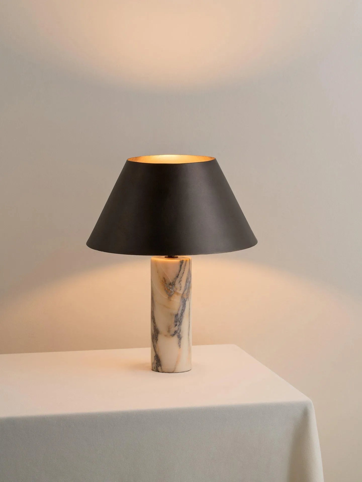 Black marble table lamp with modern simple design on wooden surface