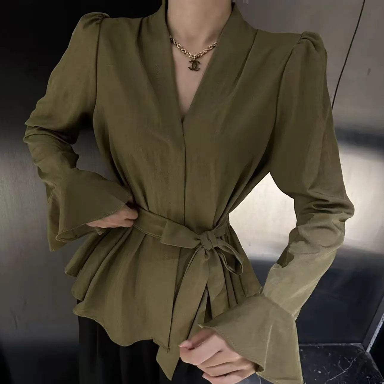 Women's French-style irregular collar shirt with long bell sleeves and tie front detail in polyester fabric.