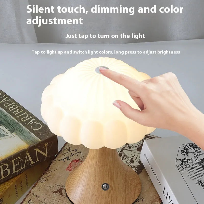 Mushroom-shaped touch control night lamp in wood grain colour on a wooden table.