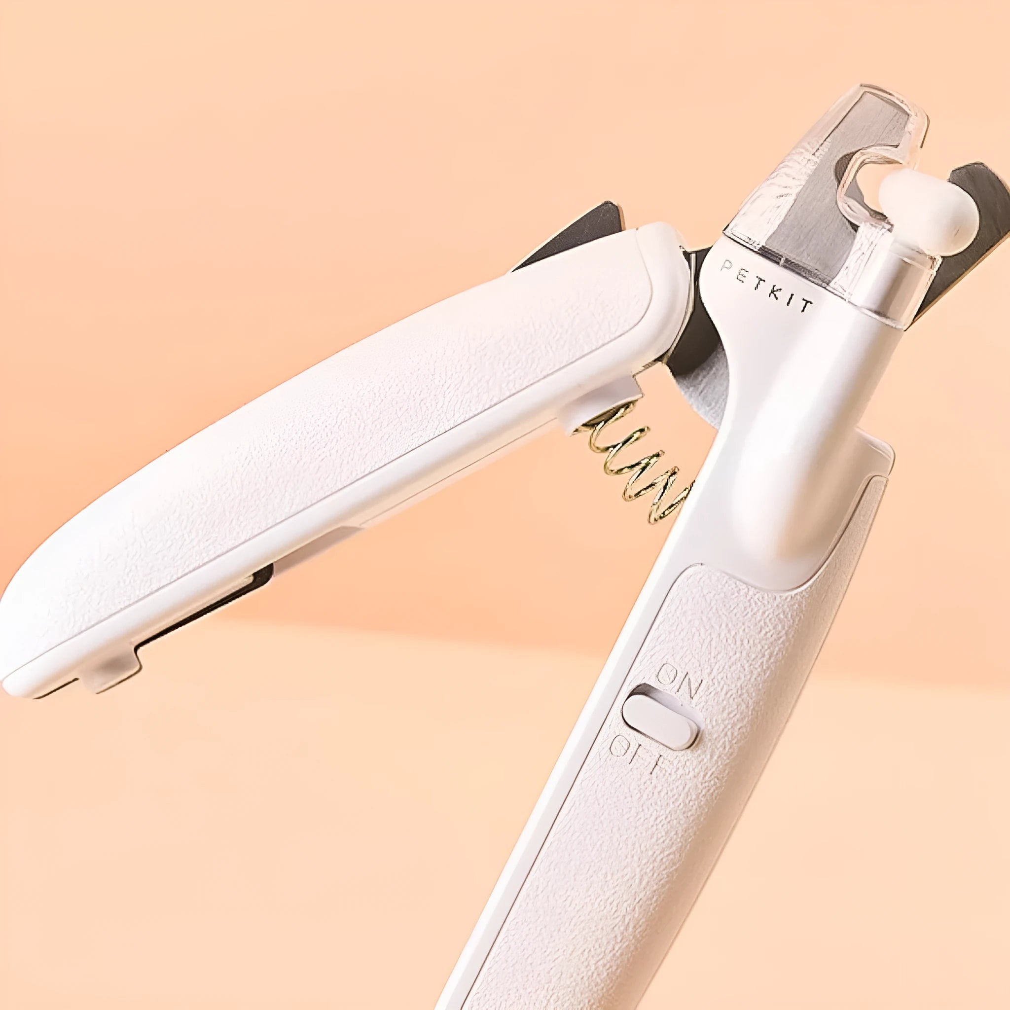 White pet nail clippers with LED light, transparent anti-splash baffle, and a nail file.