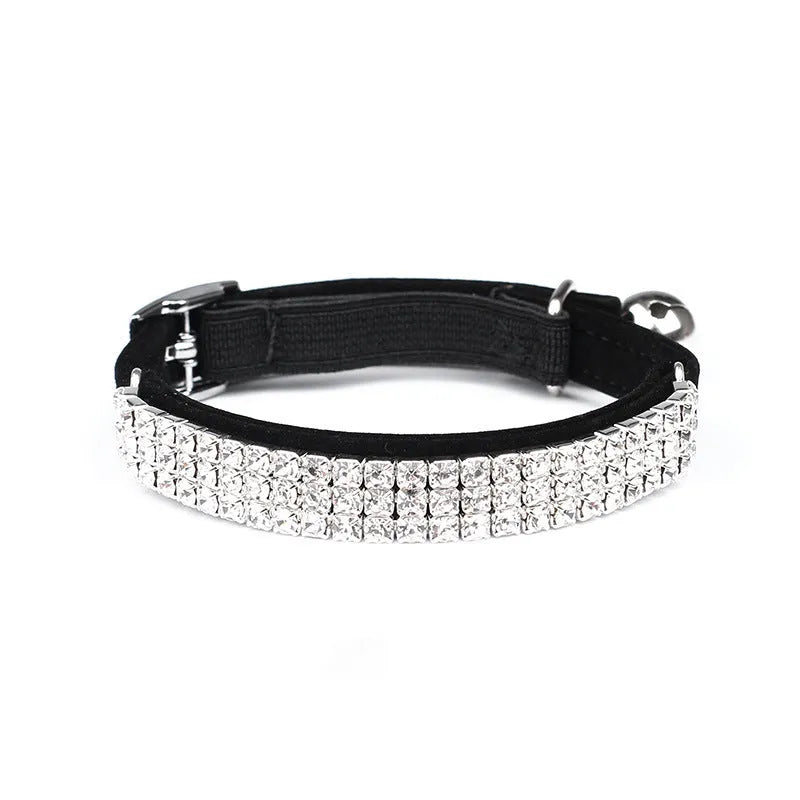 Velvet suede cat collar with rhinestone decoration in various colours on a white background.