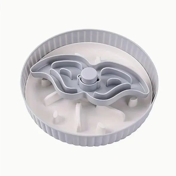Grey rotating pet slow feeder bowl with a blue silicone windmill-pattern licking mat attached.