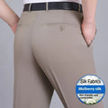 Man wearing dark blue straight-leg suit trousers with a high waist, made from a mulberry silk blend fabric.