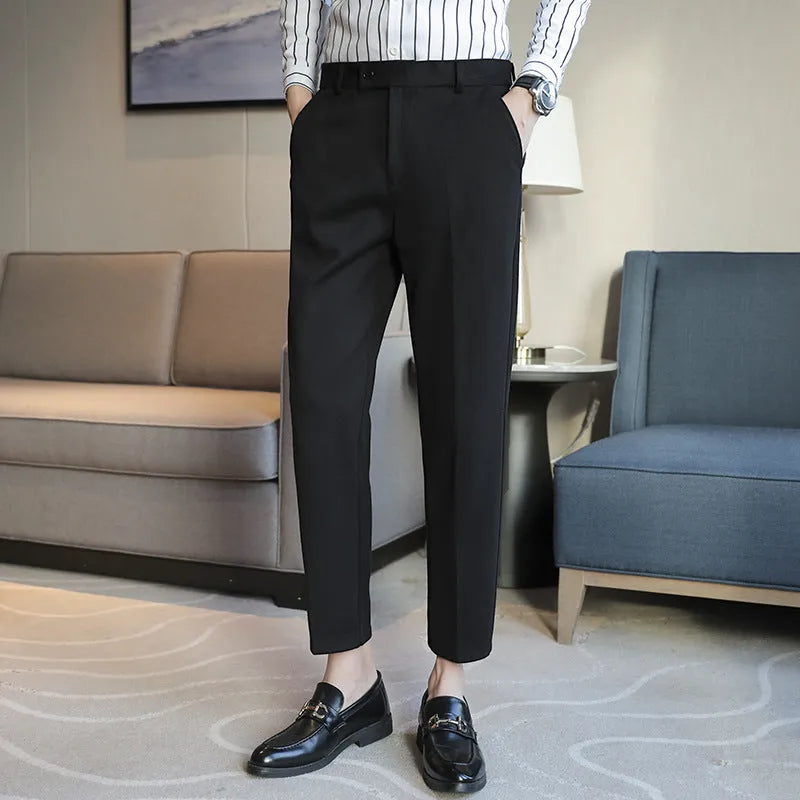 Men's straight leg brown corduroy trousers with an elasticated waistband on a hanger
