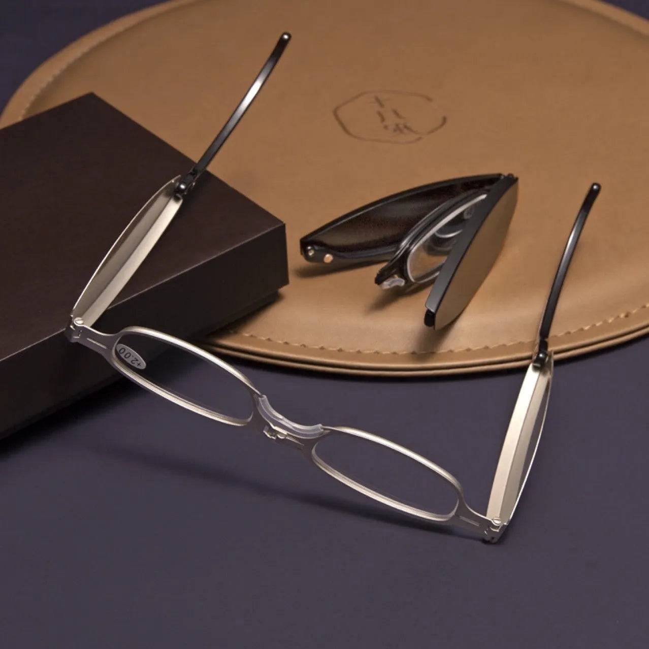 Black retro-style folding reading glasses for men, shown open and folded