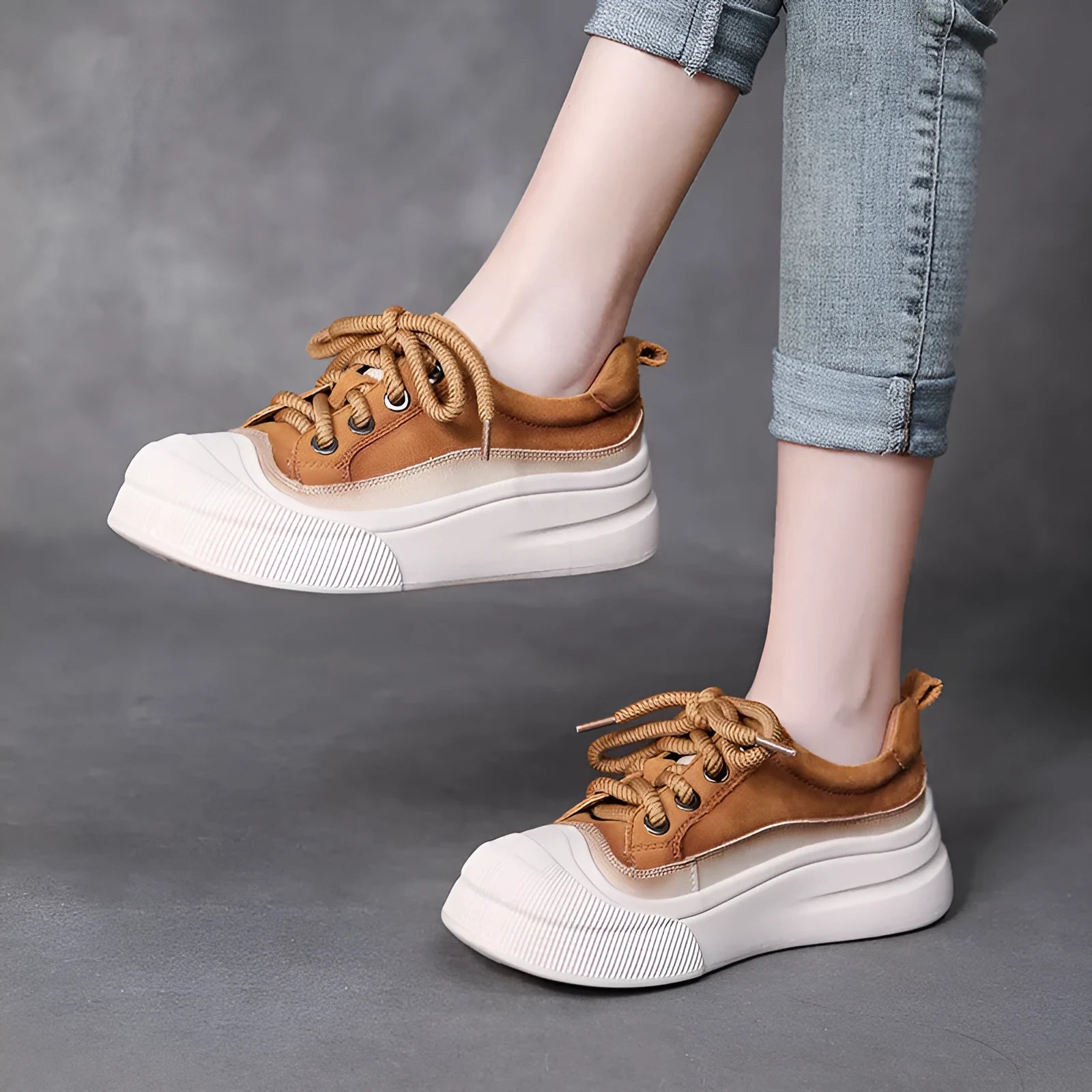 Women's yellow lace-up casual leather shoes with round toe and rubber sole on a neutral background.