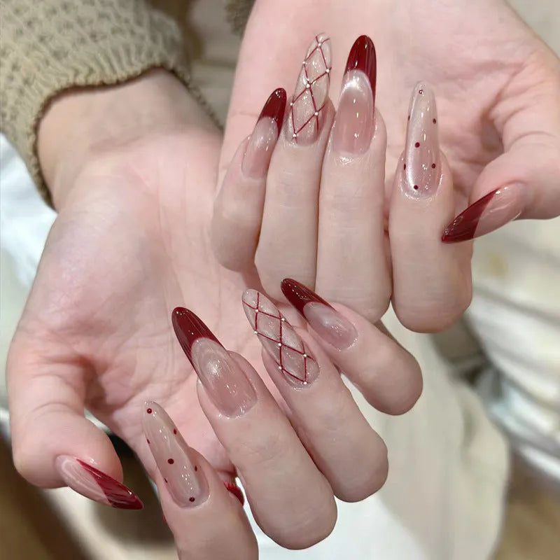 False nails with hand-glued crystal decorations in random mixed colours creating 3D nail art designs