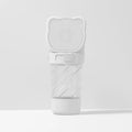 Green 3-in-1 portable pet water bottle with food container and waste bag dispenser attached to a strap.