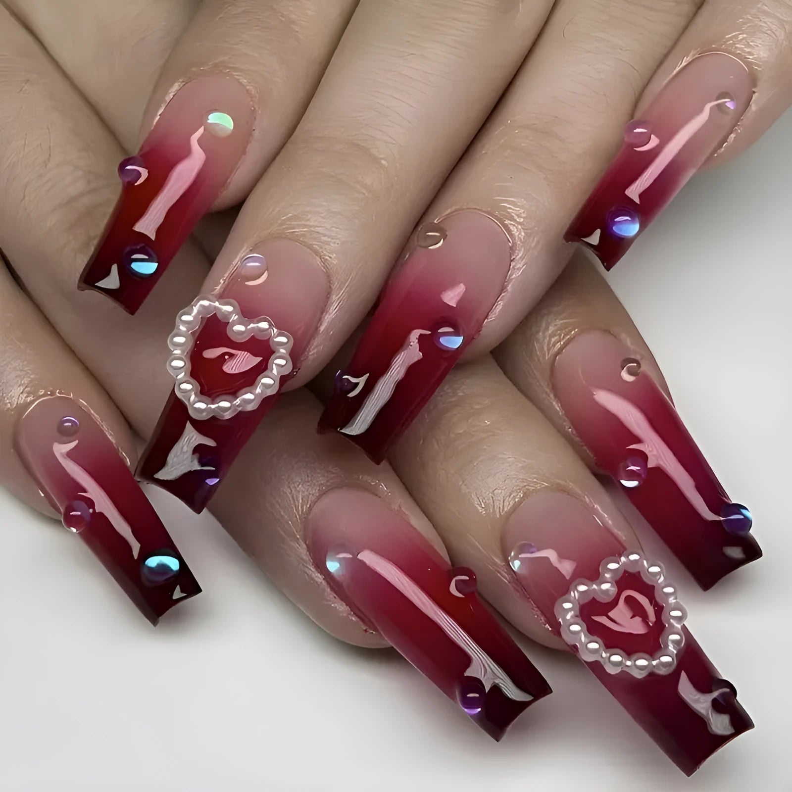 Wine red gradient false nail tips with heart and pearl pattern in long ballet style