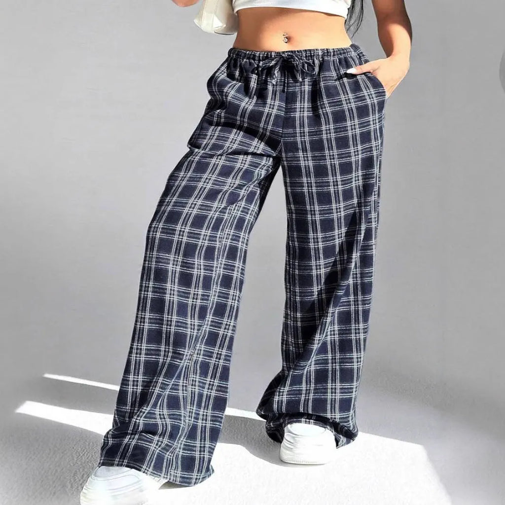 Women's red plaid loose trousers with drawstring waist and side pockets laid flat