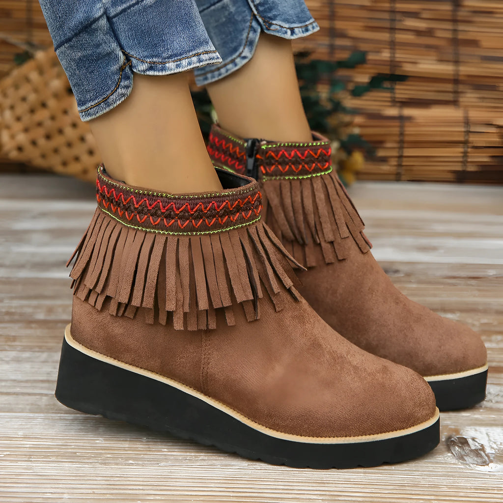 Women's dark brown suede wedge ankle boot with side zip, tassel, and thick rubber sole.