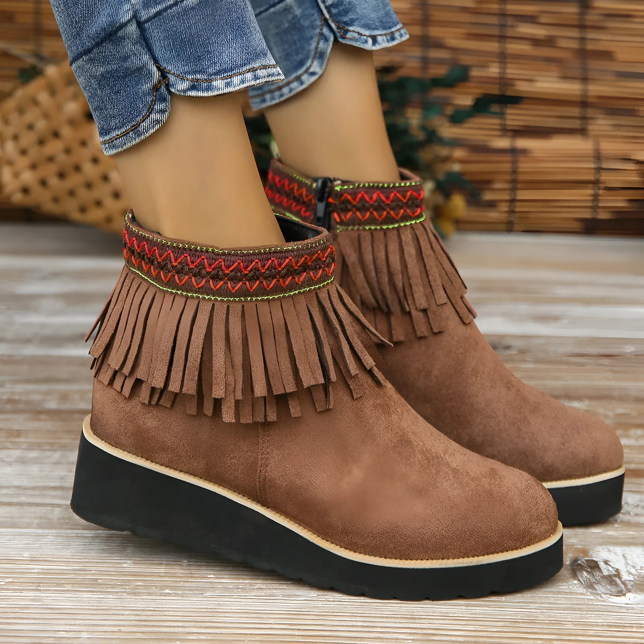 Women's dark brown suede wedge ankle boot with side zip, tassel, and thick rubber sole.