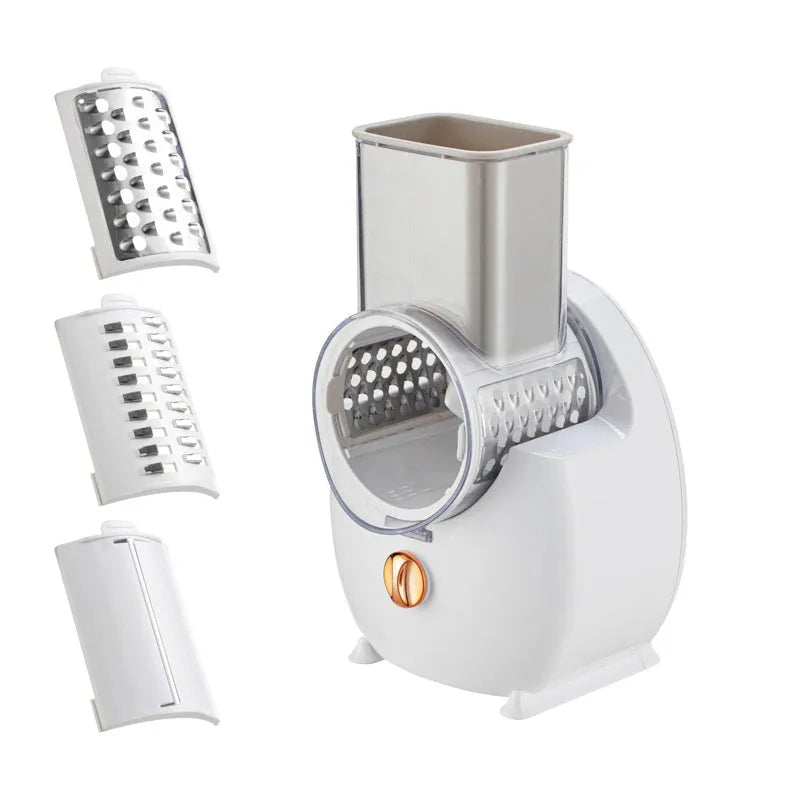 White electric vegetable slicer with rotary grater, three blades, and suction base on kitchen counter