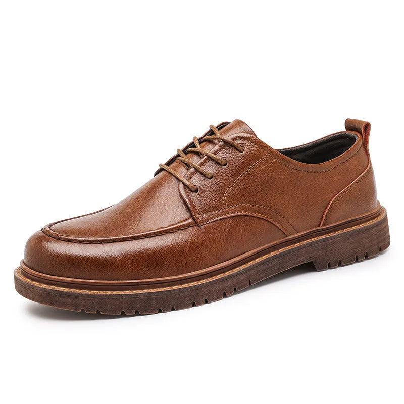 Men's black casual leather shoes with sewing line details and a round toe on a flat rubber sole.