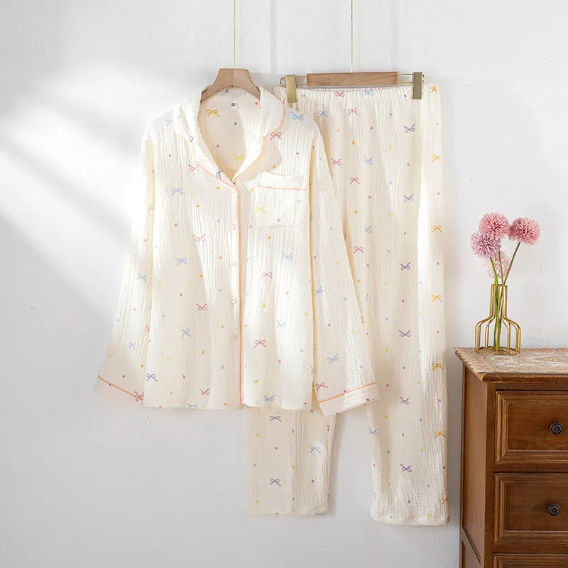 Women's beige long sleeve cotton pajama set with trousers, laid flat.