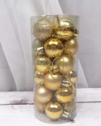 Shiny matte gold, red, silver, and blue 3 cm Christmas baubles spilling from a cardboard box.