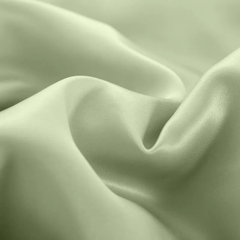 Reversible silk duvet cover folded to show Lotus Pink and pea green sides, with bright brown and silver blue colour swatches.