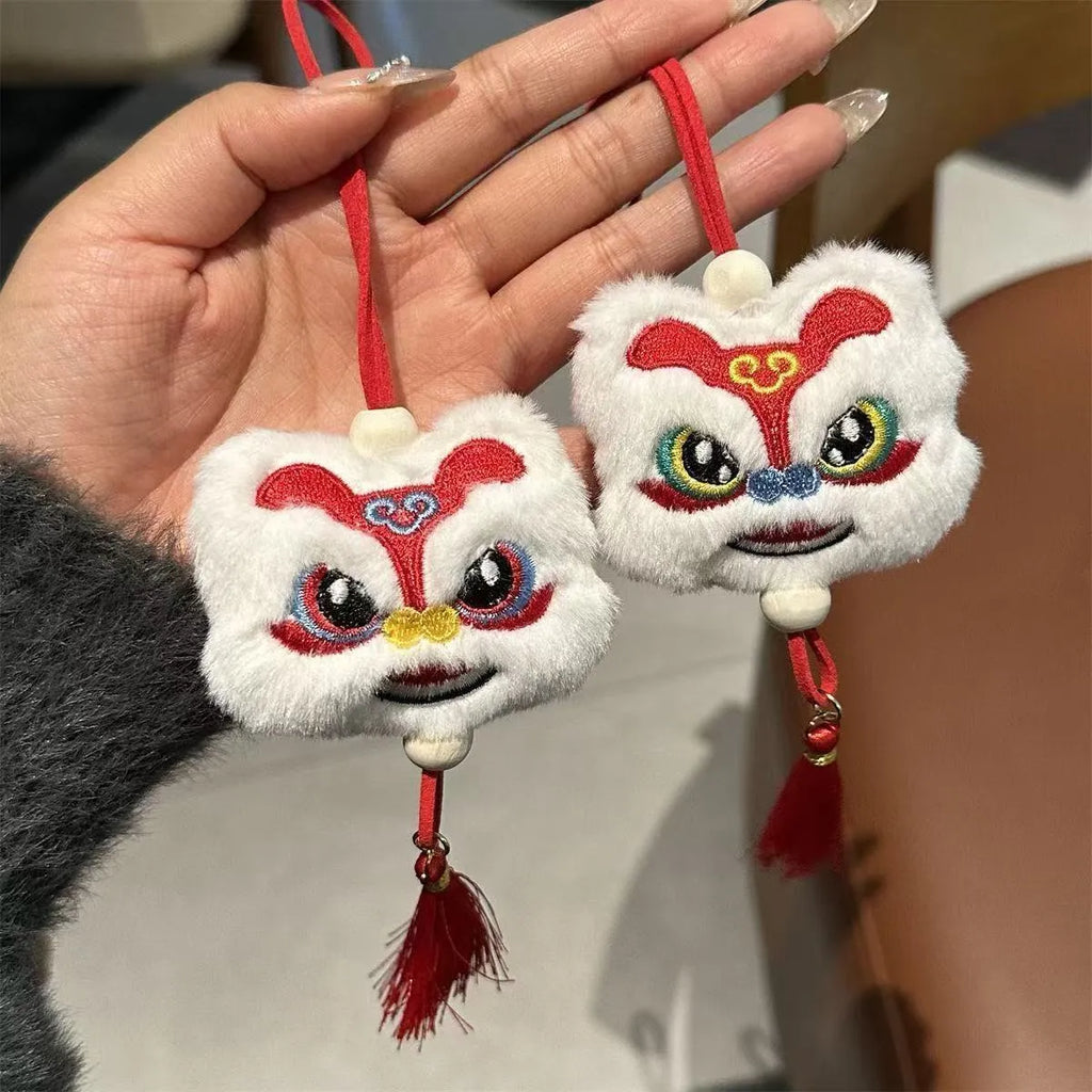 Blue and yellow handmade plush lion keychain ornaments with star stone decoration on white background.