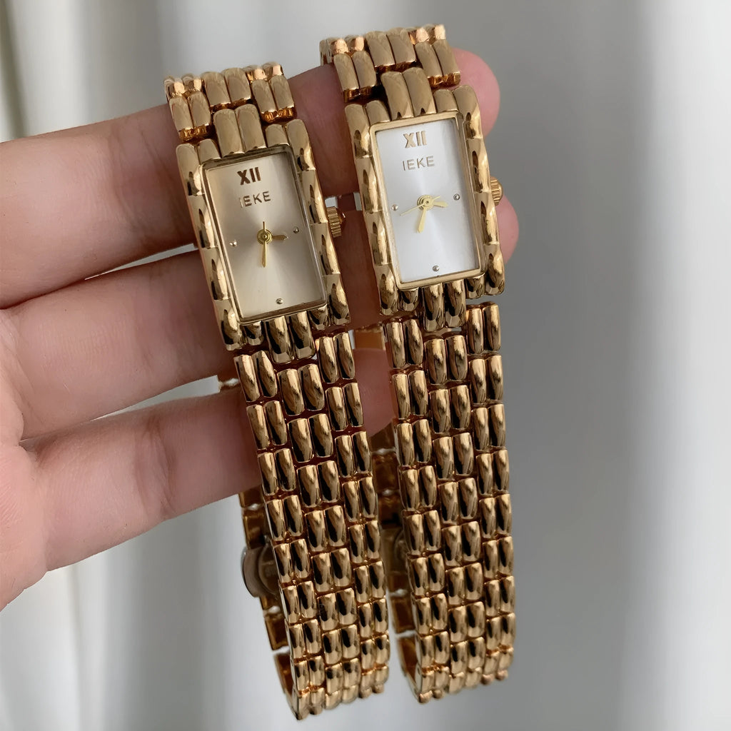 Women's vintage bracelet watch with a small dial, butterfly buckle, on a silver strap.