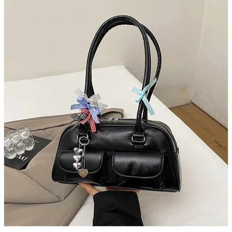 Brown PU leather retro pillow bag for women with a flap closure and double shoulder strap.