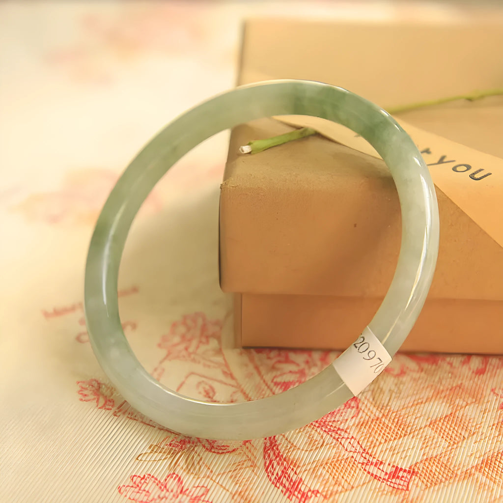 Green jade waxy geometric bracelet with unisex Chinese style design on a wrist.