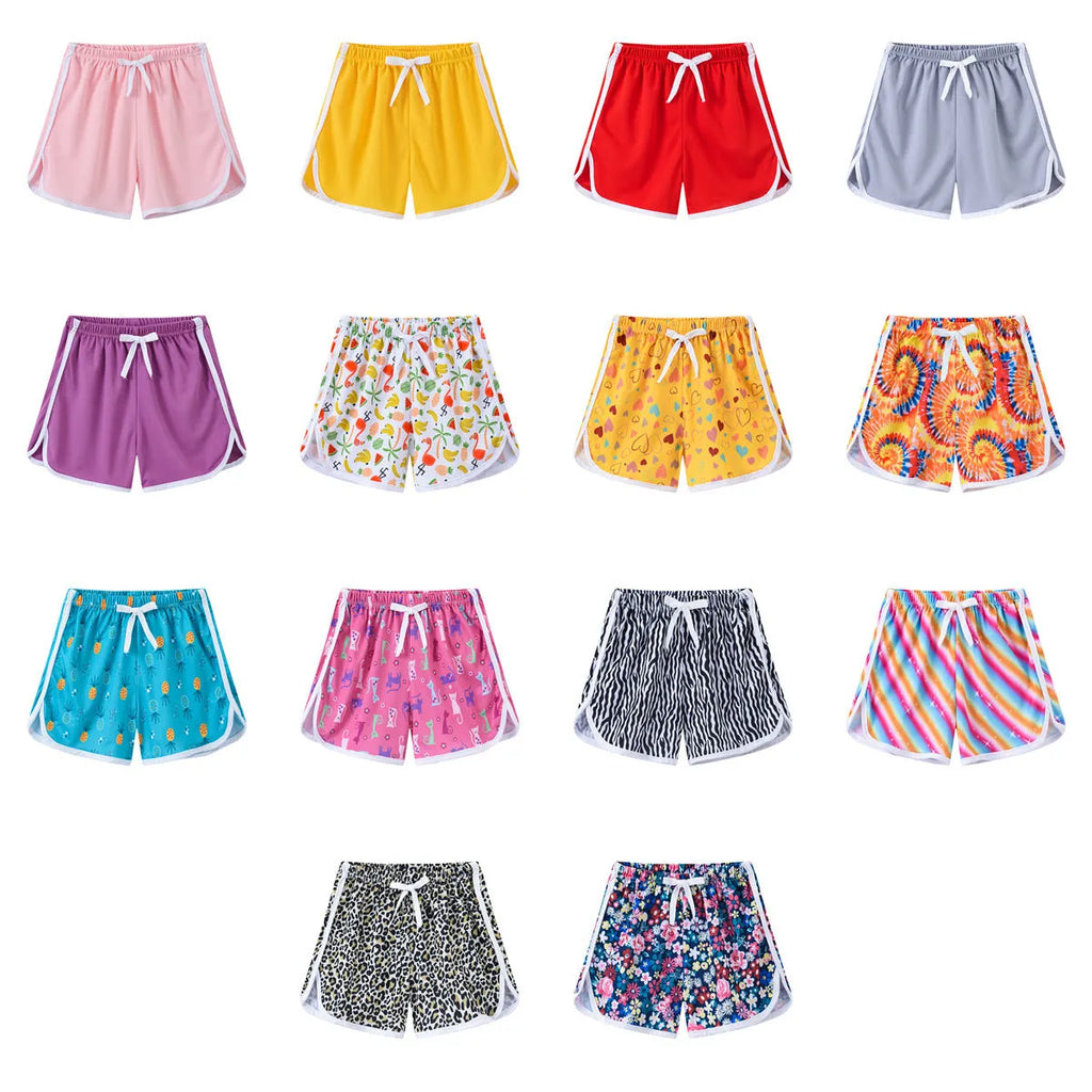 Children's polyester beach shorts in various colours and patterns including stripes, prints and solid options