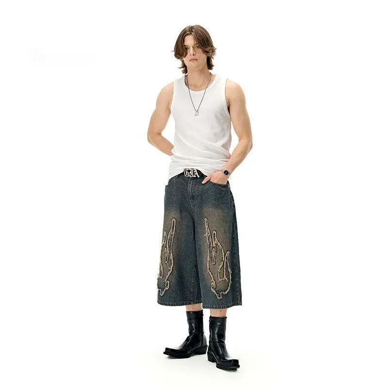 Men's black denim shorts with flame embroidery and patchwork design, straight leg cut