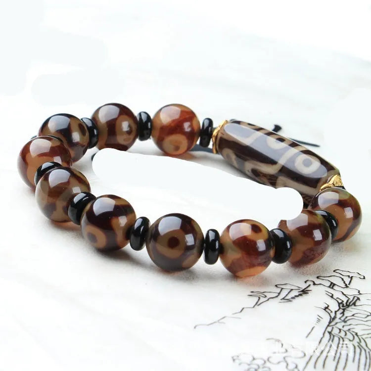 Agate Tibetan dzi bead bracelet with three-eye design and polished finish