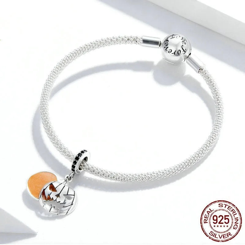 S925 sterling silver Halloween beaded bracelet with pumpkin and skull charms on a neutral background