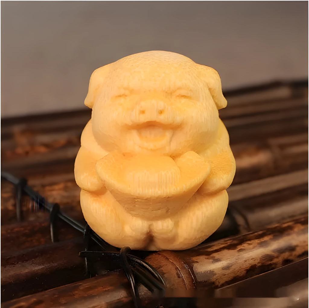 Solid bamboo carving ornament of an ingot pig, 4cm tall, on a wooden surface.