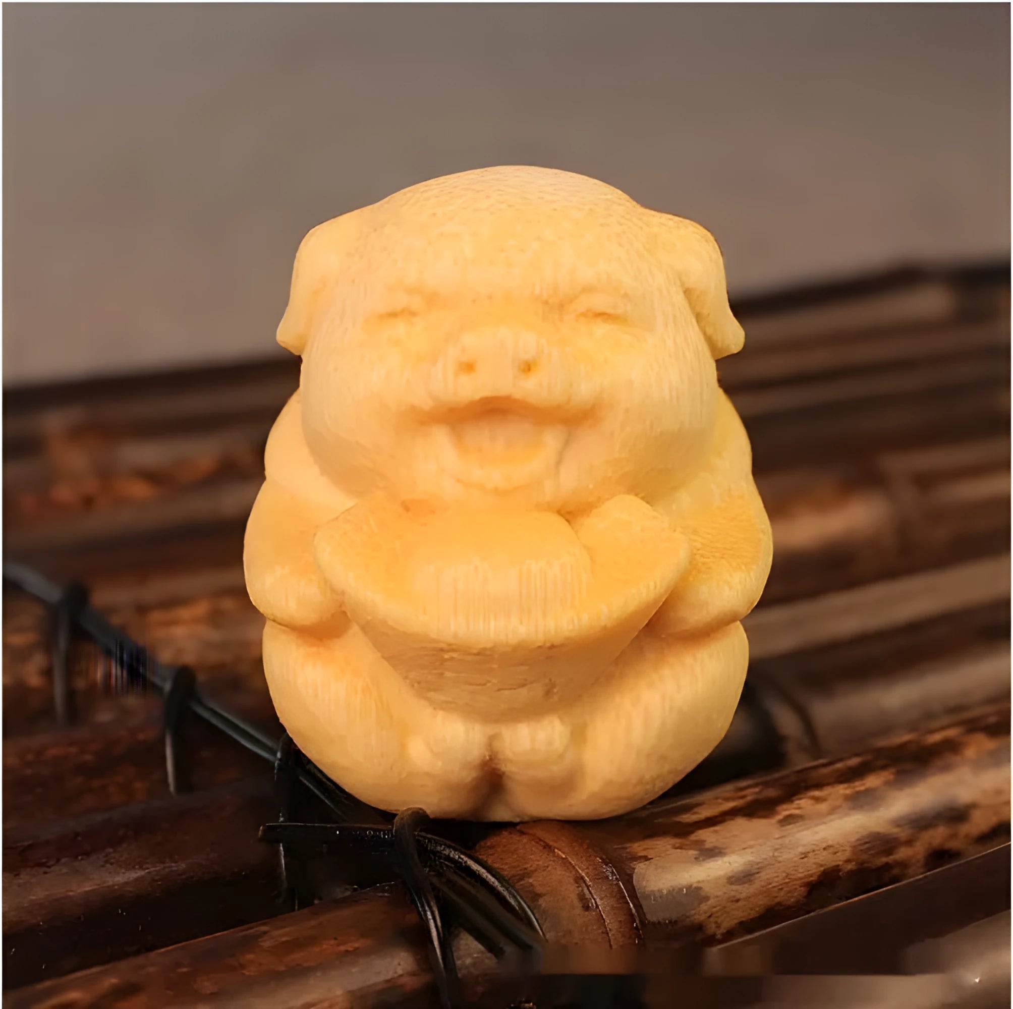 Solid bamboo carving ornament of an ingot pig, 4cm tall, on a wooden surface.