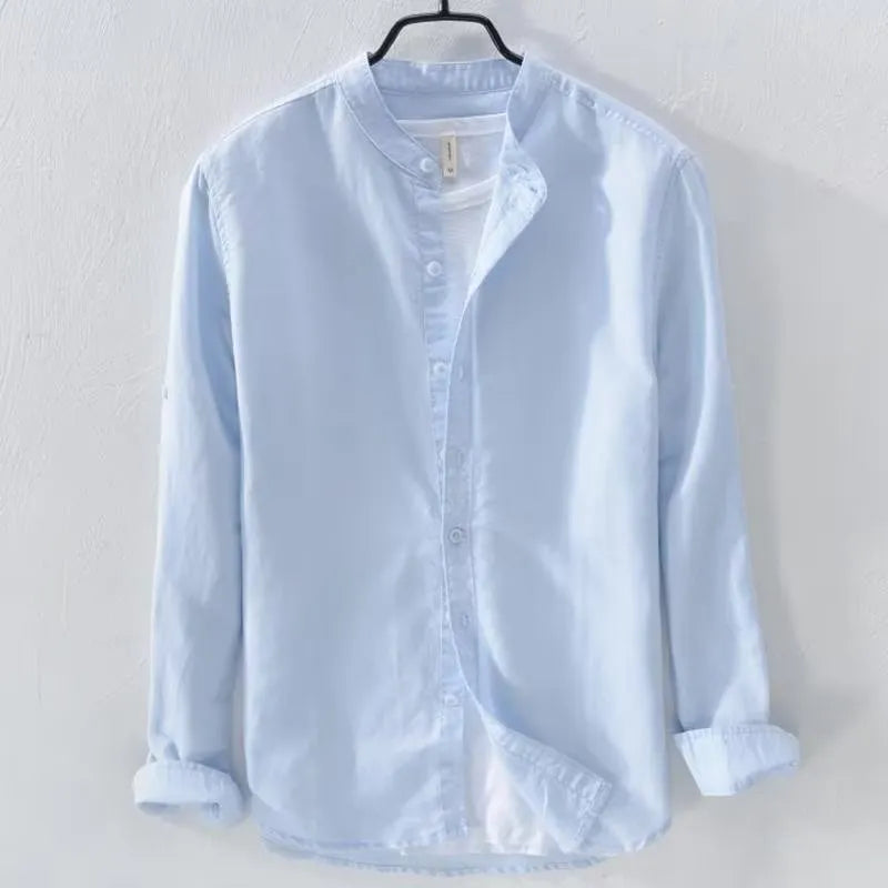 Man's loose fit long sleeve linen shirt in dark blue, showing button front and casual style.